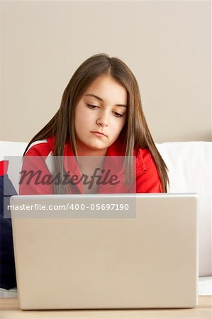 Young Girl Using Laptop At Home