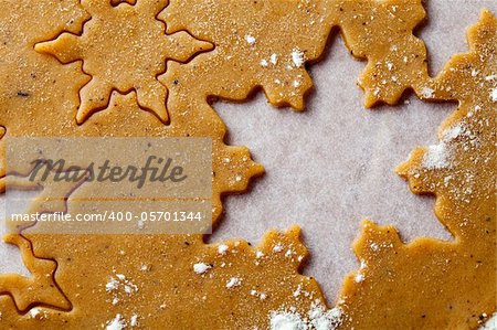 Making gingerbread cookies for Christmas. Gingerbread dough with star shapes.