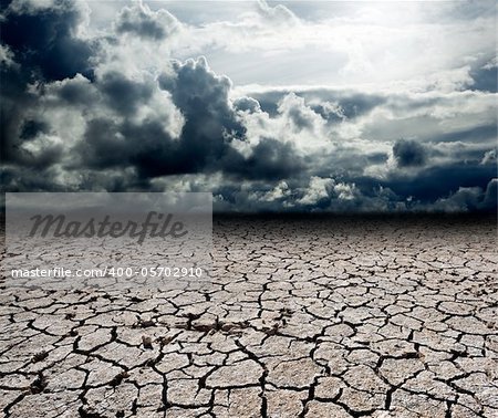 Landscape with storm clouds and dry soil