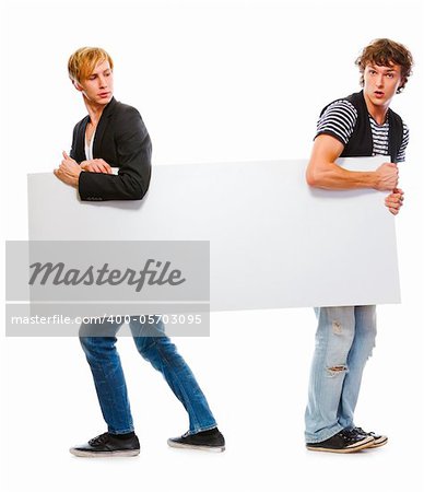 Two modern teenagers holding blank billboard. Isolated on white