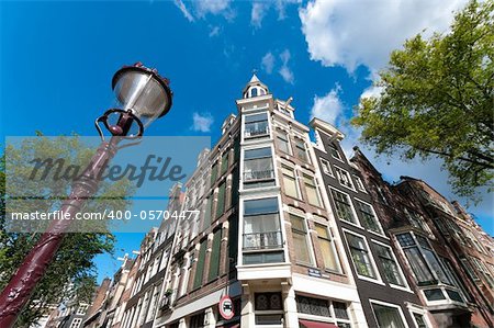 low angle view of some typical amsterdam houses and a lamppost