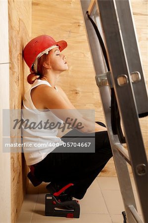 caucasian woman as worker wearing red protective helmet