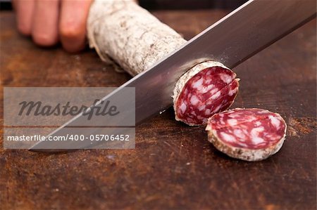 Butcher Slicing Salami