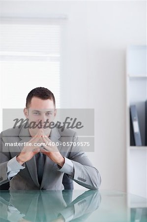 Close up of young businessman sitting behind a table in a successful negotiation