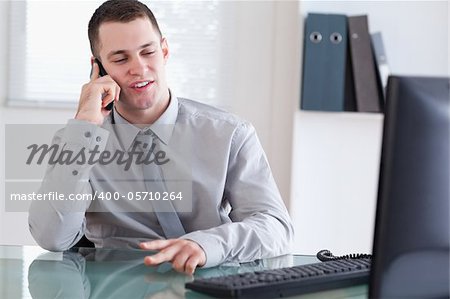 Young businessman talking to costumer on the cellphone