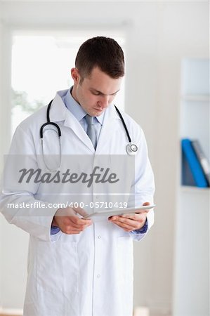 Doctor having a close look at his tablet