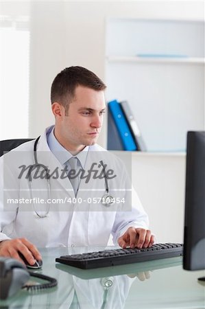 Young doctor working on his computer