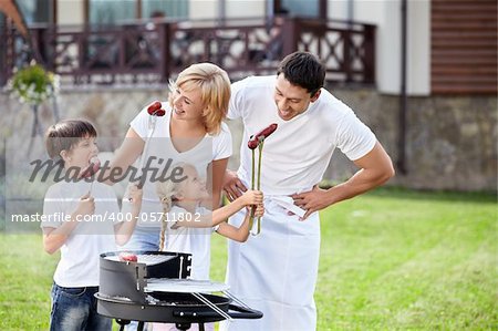 Parents with children at barbecue