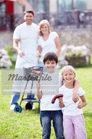 Happy family with children make barbecue