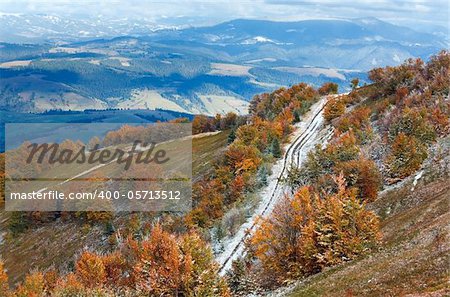 October Carpathian mountain plateau with first winter snow and autumn colorful foliage