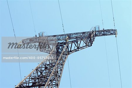High voltage Electricity pylon against blue sky