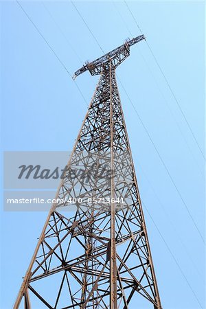 High voltage Electricity pylon against blue sky