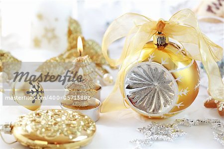 Christmas decoration with ball and candles in golden tone