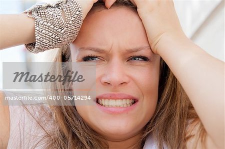 Young panic woman with hands on the head