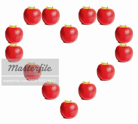 Red apples shaping a heart on white background