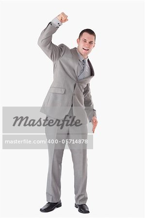 Portrait of a businessman cheering up against a white background