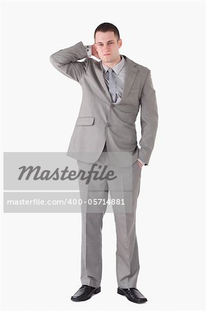 Portrait of a tired young businessman against a white background