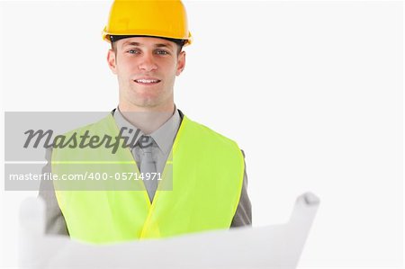 Builder holding a plan against a white background