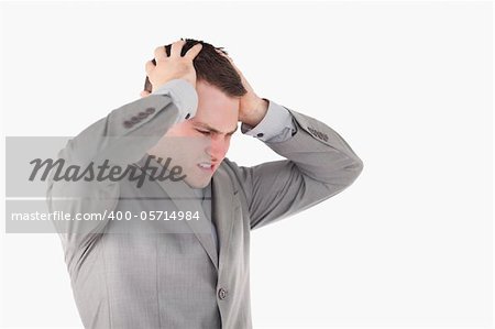 Worried young entrepreneur against a white background
