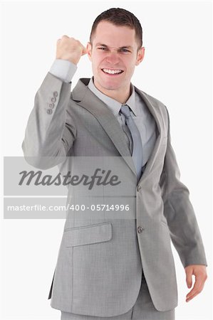 Portrait of a businessman with his fist up against a white background