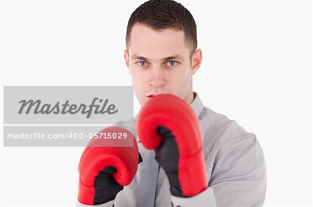 Businessman ready to fight against a white background