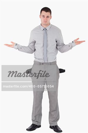 Portrait of a young businessman with empty pockets against a white background