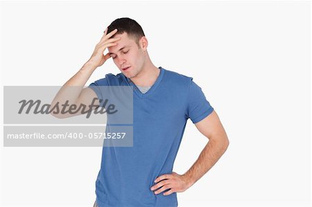 Tired young man against a white background