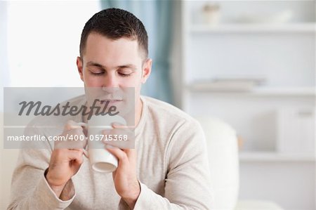 Man having a tea in his living room