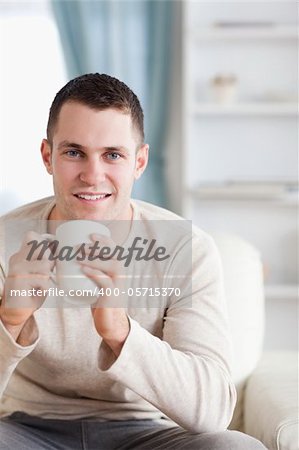 Portrait of a man having a coffee in his living room