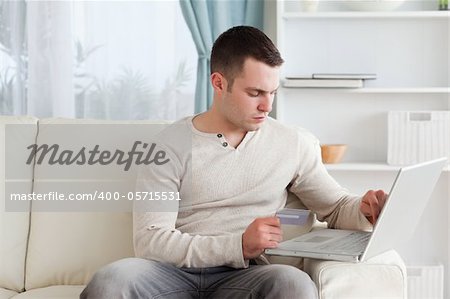 Man shopping online in his living room