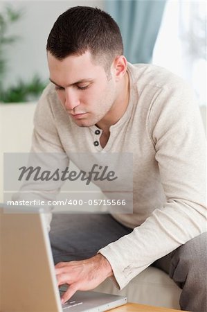 Portrait of a young man using a notebook in his living room