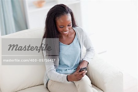 Smiling young woman happy about textmessage