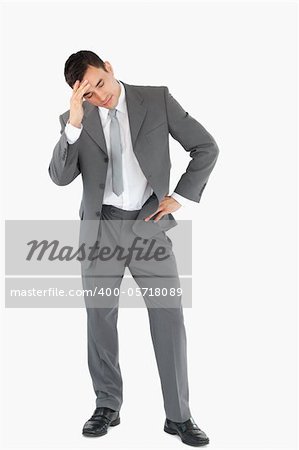 Businessman experiencing a setback against a white background