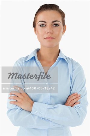 Confident businesswoman with arms folded against a white background