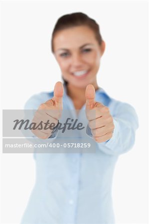 Smiling businesswoman giving her approval against a white background