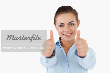 Smiling businesswoman approving against a white background