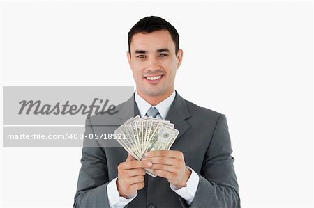 Businessman with money against a white background