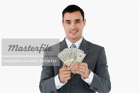 Businessman with bank notes against a white background