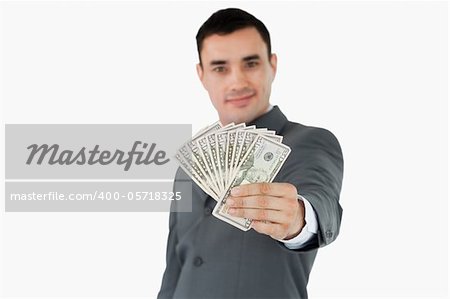 Businessman presenting bank notes against a white background