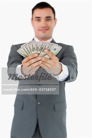 Businessman presenting his banknotes against a white background