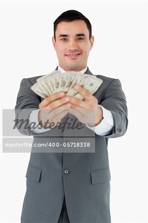 Smiling businessman presenting his bank notes against a white background