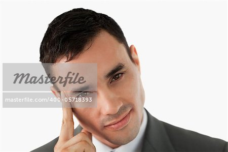 Close up of young businessman in thoughts against a white background