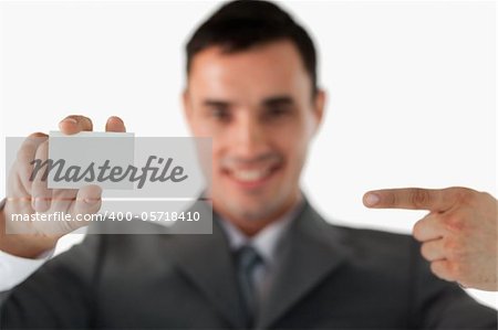 Businessman pointing at business card against a white background