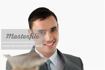 Close up of businessman with banknotes against a white background