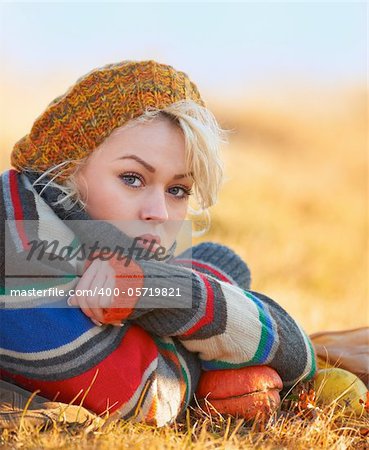 Portrait of a sad young woman outdoor in autumn.