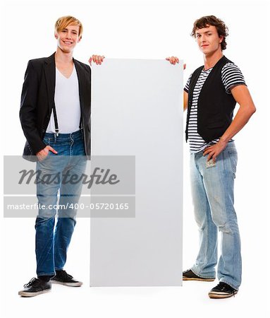 Two modern teenagers holding blank billboard. Isolated on white
