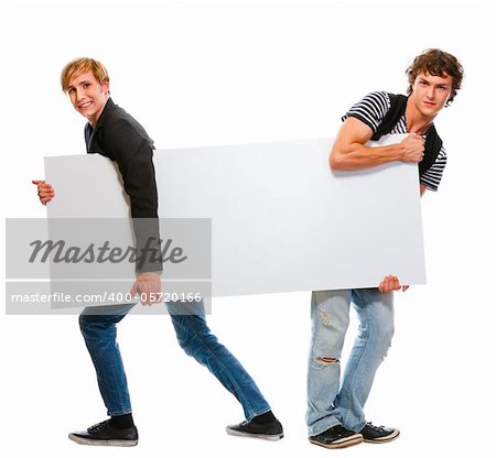 Two teenagers pulling blank billboard. Isolated on white