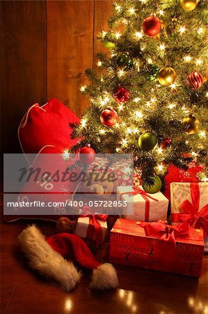 Closeup of brightly lit Christmas tree with gifts