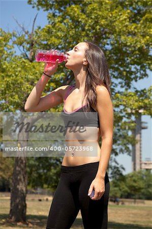 Young female drinking after running