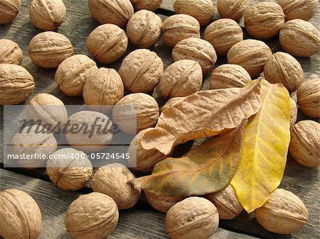 walnuts with leaves on old wooden background